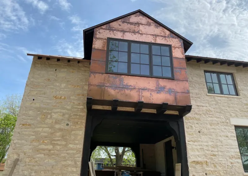 Copper metal panel facade on a stone building for Skylight Installation in Littleton